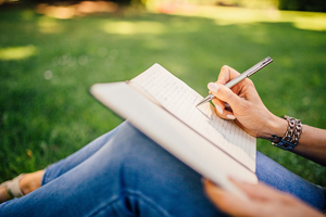 woman writing in park